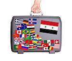 Used plastic suitcase with lots of small stickers, large sticker of Syria