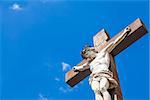 Crucifix made of marble with blue sky in background. France, Provence Region.