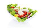 Delicious colorful vegetable salad in white bowl isolated on white background. Healthy vegetable eating.