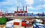 Port warehouse with containers and industrial cargoes at day