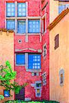 Detail of nice colorful wall with doors and windows, Sardinia, Italy