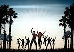Silhouettes of people dancing on a summer background
