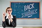 Thinking redhead businesswoman against blackboard with copy space on wooden board