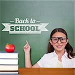 Cute pupil pointing against back to school message