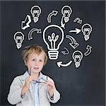 Cute pupil holding glasses against idea and innovation graphic