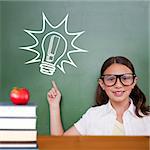 Cute pupil pointing against red apple on pile of books