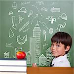 Red apple on pile of books against cute pupil holding chalk