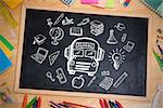 Composite image of education doodles against chalkboard