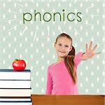 The word phonics and cute girl with hand out against red apple on pile of books