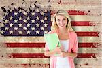 Young pretty student smiling against usa flag in grunge effect