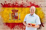 Mature student holding notebooks against spain flag in grunge effect