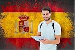 Student using tablet pc against spain flag in grunge effect