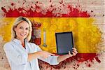 Mature student pointing to tablet against spain flag in grunge effect
