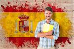 Young student smiling against spain flag in grunge effect