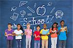 Elementary pupils reading books against blue chalkboard with back to school message