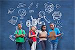 Cute pupils smiling at camera  against blue chalkboard with school doodles