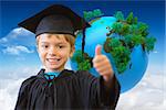 Cute pupil in graduation robe against bright blue sky with clouds with globe