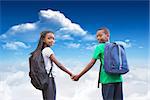 Cute pupils holding hands against bright blue sky with clouds