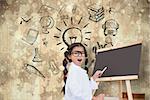 Cute pupil with chalkboard against paint splattered paper