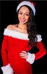 Pretty brunette in santa outfit smiling at camera on black background