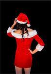 Thinking brunette in santa outfit posing with hand on hip on black background