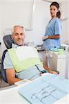 Patient smiling at camera sitting in the chair at the dental clinic