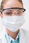 Dentist with surgical mask and protective glasses at the dental clinic