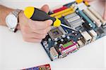 Computer engineer working on cpu with screwdriver in his office