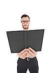 Frowning minister holding out black bible on white background