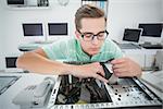 Technician working on broken computer in his office