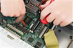 Technician working on broken cpu with soldering iron in his office