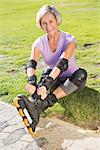 Active senior woman ready to go rollerblading on a sunny day