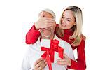 Smiling woman covering partners eyes and holding gift on white background