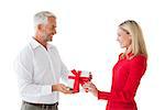 Smiling couple holding a gift on white background