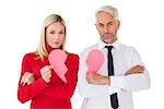 Couple not talking holding two halves of broken heart on white background