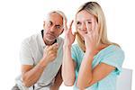 Unhappy couple sitting on chairs having an argument on white background