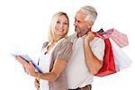 Happy couple holding shopping bags and looking at tablet pc on white background