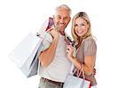 Happy couple holding shopping bags and credit card on white background