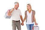 Happy couple holding shopping bags and hands on white background