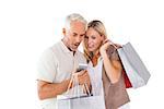 Happy couple holding shopping bags and smartphone on white background
