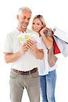 Happy couple holding shopping bags and cash on white background