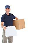 Happy delivery man holding cardboard box and clipboard on white background