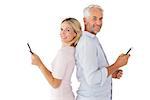 Happy couple texting on their smartphones on white background