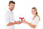 Attractive young couple holding a gift on white background