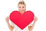 Attractive young blonde showing red heart on white background