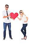 Cool young couple holding red heart on white background