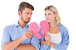 Couple holding two halves of broken heart on white background