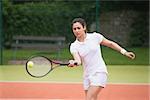 Tennis player playing on the court on a sunny day