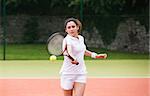 Young tennis player hitting ball on a sunny day