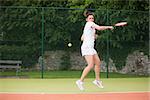 Pretty tennis player playing on court on a sunny day